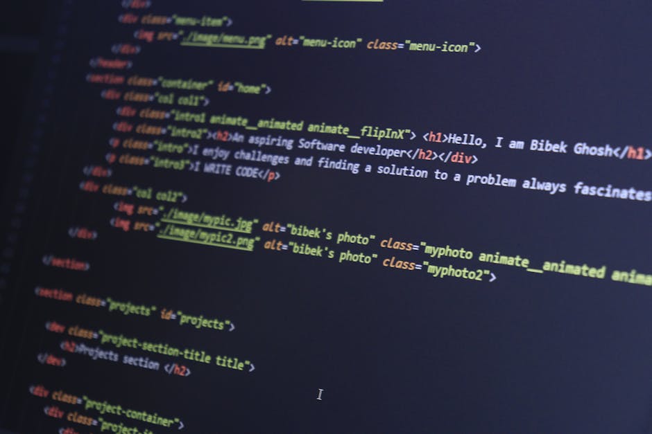 The image displays a close-up of a computer screen with lines of code in various colors, including blue, yellow, red, and green, on a dark background. The code consists of HTML markup, with identifiab